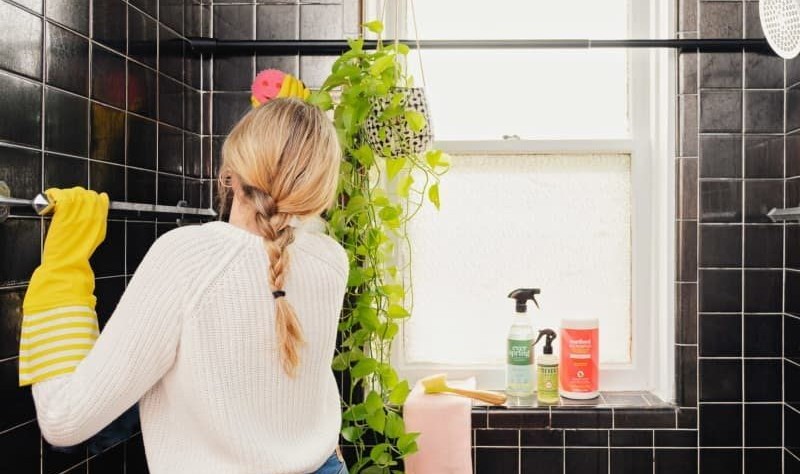 young woman sprucing up a bathroom