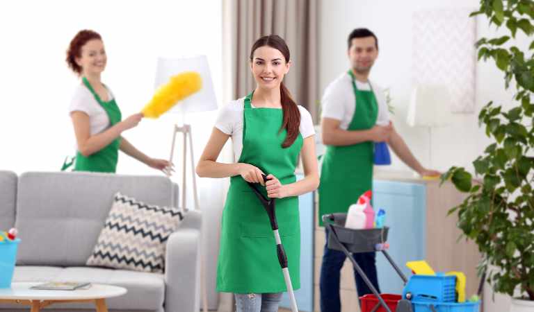 Cleaning service team working in living room
