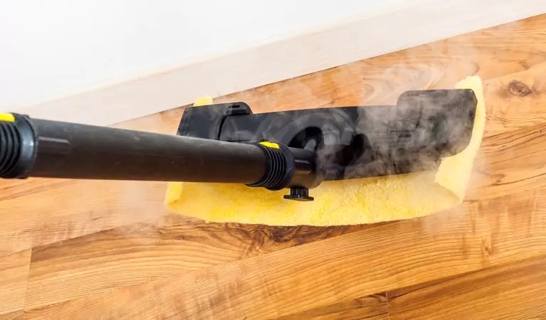 cleaning the wooden floors with a steam cleaner