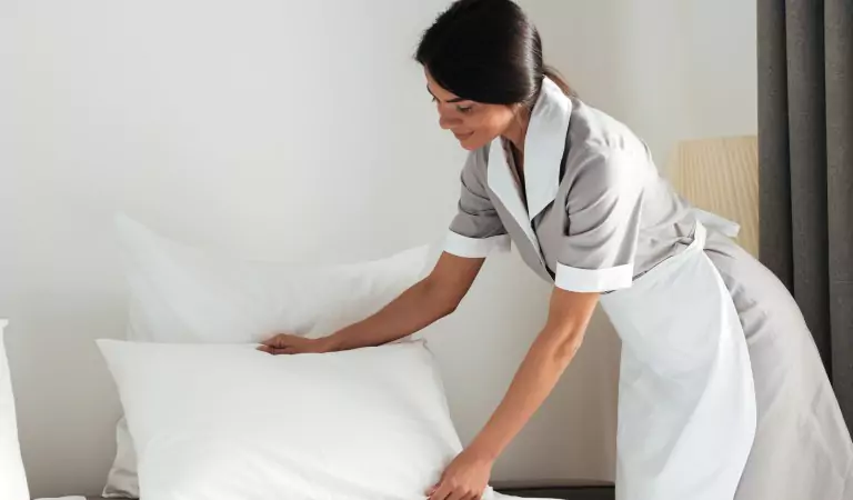 woman preparing her guest room for her guests