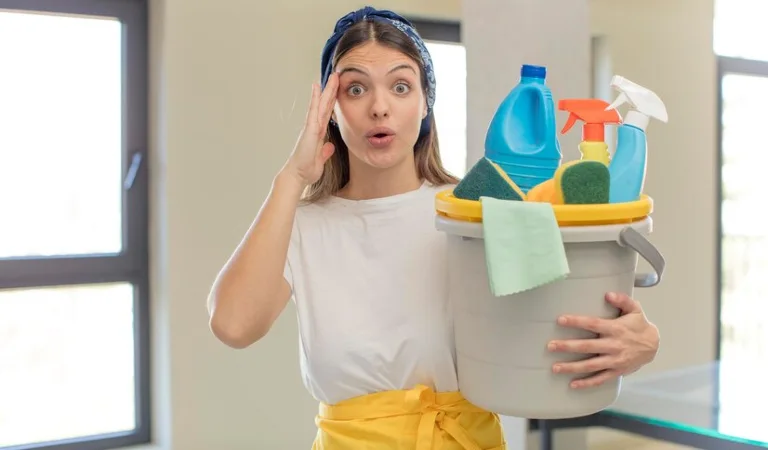 Lady in white yellow dress holding a cleaning basket filled with tools.