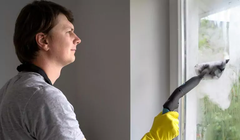 professional cleaner cleaning the window