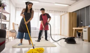 Young couple using vacuum cleaner and mop to clean home bedroom hygiene and health