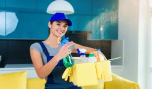 Young female professional cleaner in special uniform at apartment.
