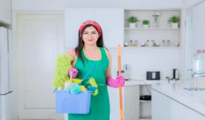 Portrait of woman carrying cleaning equipments