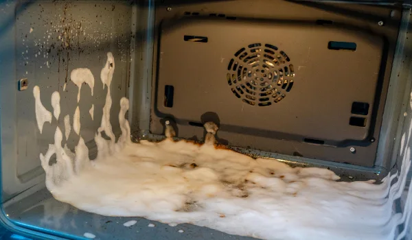 Dirty oven with cleaning foam housework and housekeeping concept products for deep oven cleaning